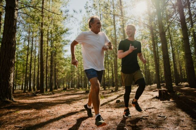 Father and Son Running in a Forest